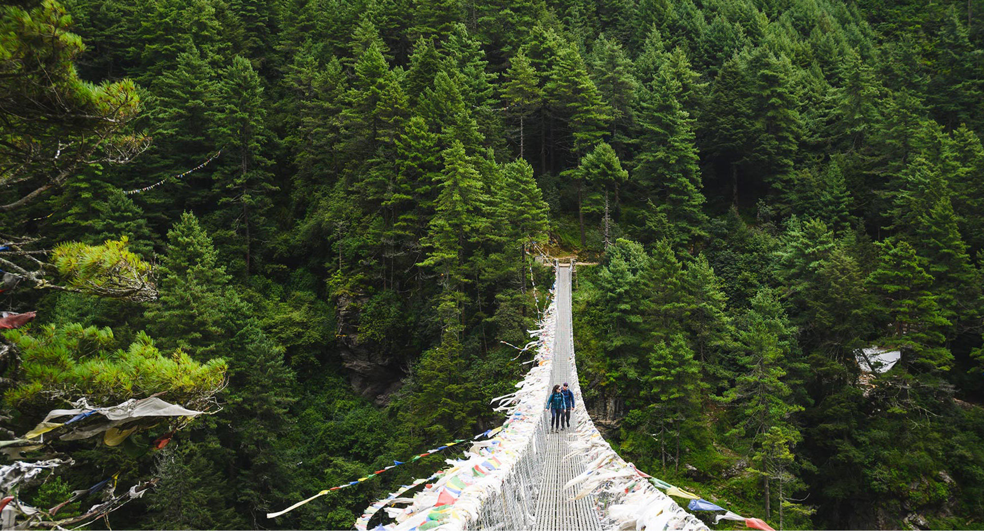 Trekking over suspension bridge shot