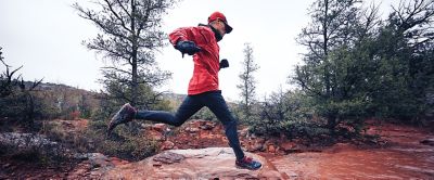 Man running on dirt trail. 