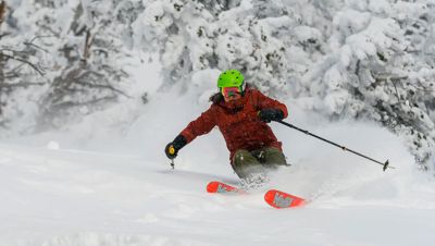 Whiteout, fresh powder conditions as a skier comes down the mountain in the backcountry.