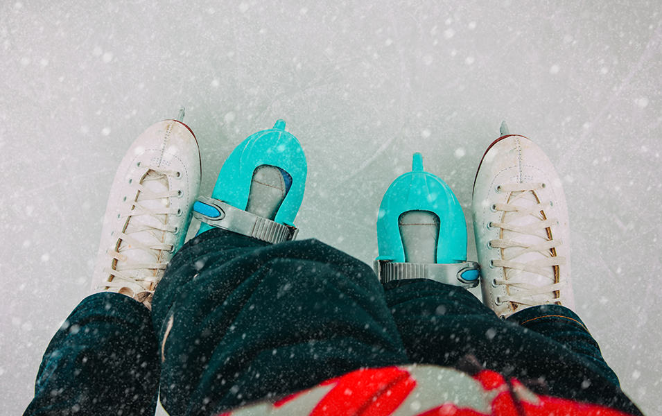 Close up of kids and adults ice skates. 