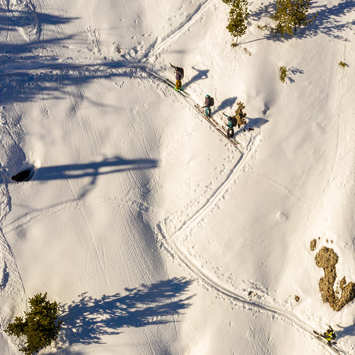 Ariel shot of a group of skiers skin their way up in the backcountry