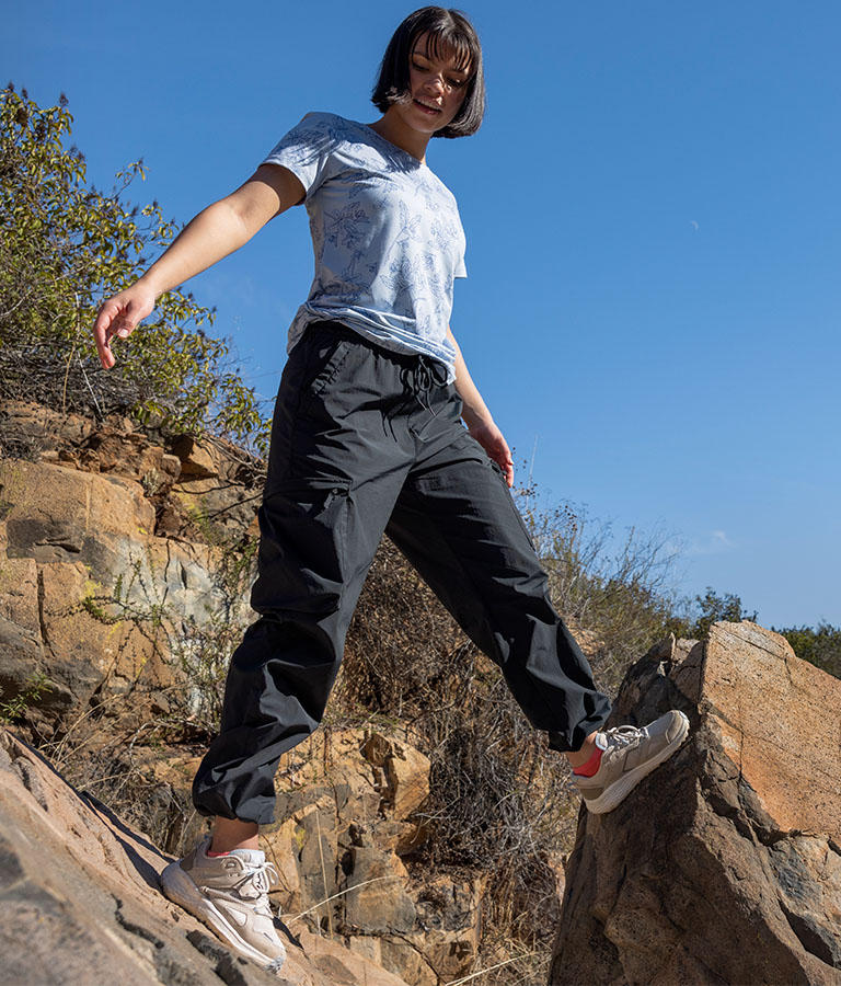 A woman hiker in lightweight trail clothes and the walking in the desert with the Bethany shoe on.