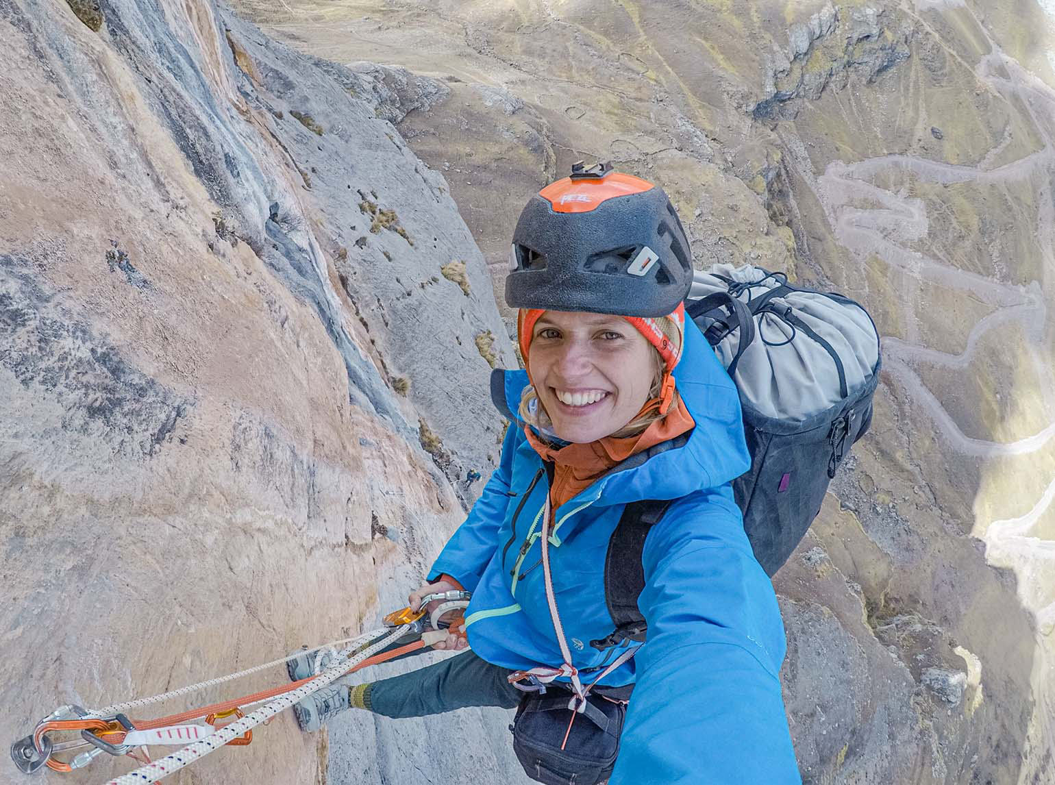 Charlotte taking a selfie while at the top of a climbing route in Peru