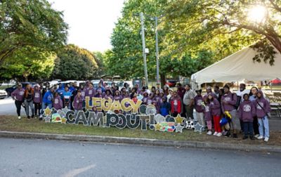 A group of staff, volunteers, and youth pose for the camera during a Greening Youth Foundation Legacy Campout. 
