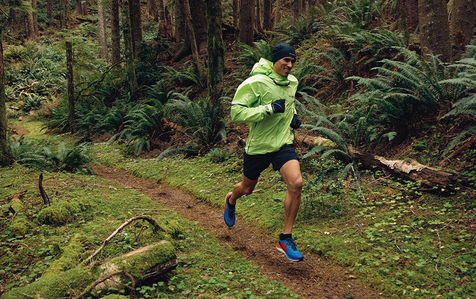 Man running on a forested trail. 