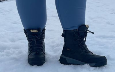A close-up shot of a pair of black Columbia Sportswear winter boots standing in the snow.  