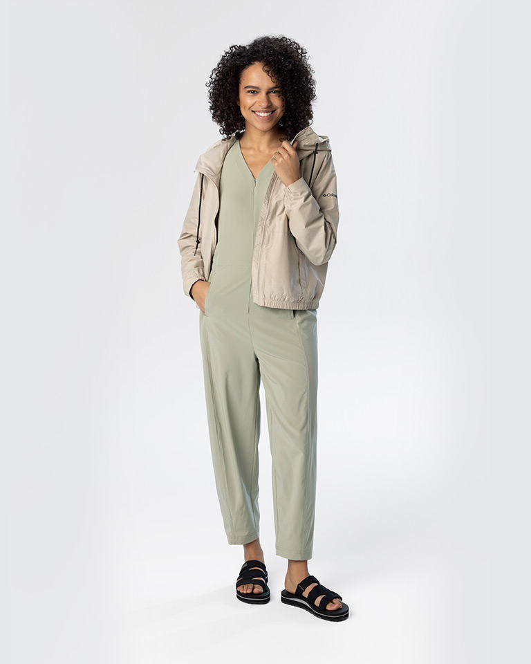 Outfit 1, a light green jumpsuit with a tan waterproof jacket and sandals.