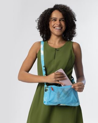 Outfit 8, a green sweat wicking midi dress with pockets, a tropical print jacket that turns into a purse, and black sandals.