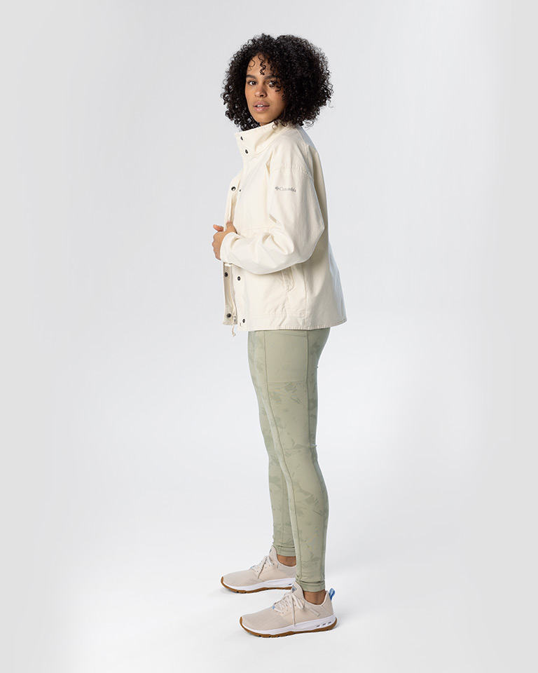 Outfit 9 an off-white cotton jacket with green leggings with pockets and tan sneakers.
