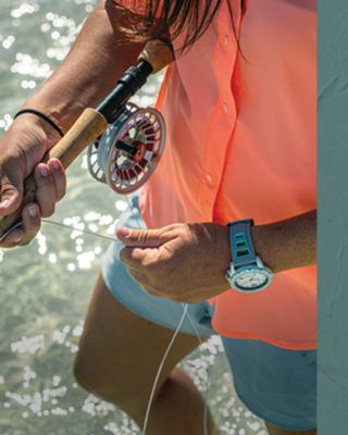 A zoomed out view of two people hiking along a ridgeline