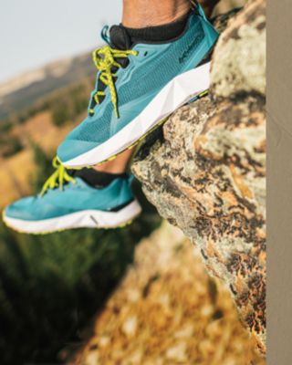A close up of feet in Columbia footwear atop a rock