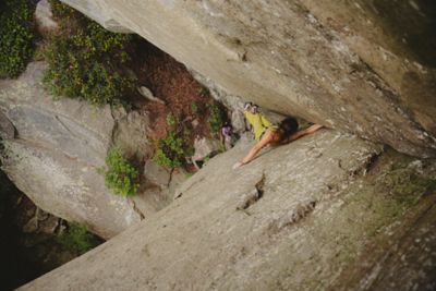A women climbing in a crack using a fist jam.