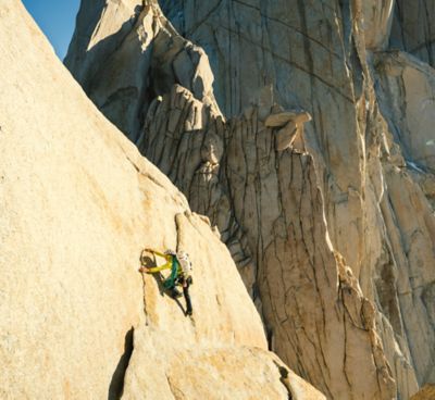 A climber makes their way up a route in sunny, bluebird conditions.