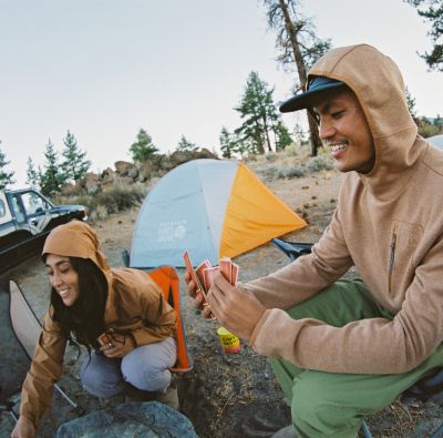 Two campers play cards at camp.