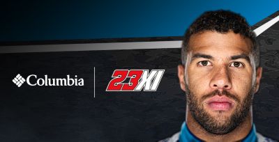 Close up of Bubba Wallace's face, Columbia logo, and the 23XI team logo on a graphic background. 