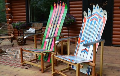 Two deck lounge chairs made by Forest Furniture sit on a deck outside. 