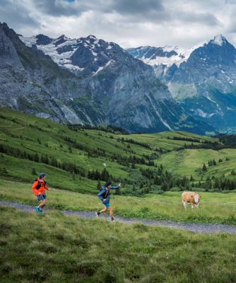 Matt and Lauren run through the Alps on a cloudy day.