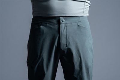 Streamlined waist with snap-button closure, internal drawcord and zippered fly