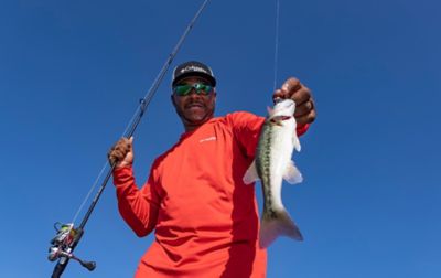 A successful Mark Daniels Jr holds up a fish he just caught. 