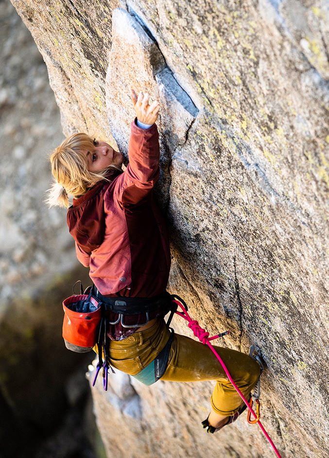 Anna climbing, reaching for her next move.