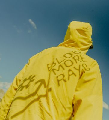 Block More Rays shadow type over a Sunshield hoody with a blue sky background.