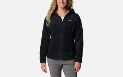 A product shot of a woman wearing a black Columbia Sportswear Benton Springs full zip hoodie with a gray background.