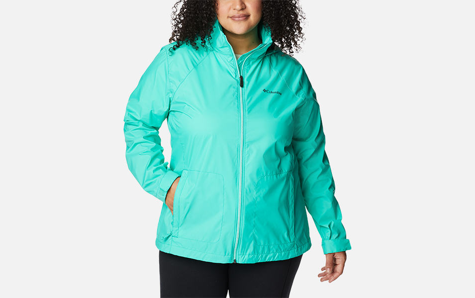 A product shot of a woman wearing a purple Columbia Sportswear Switchback III jacket with a white background.
