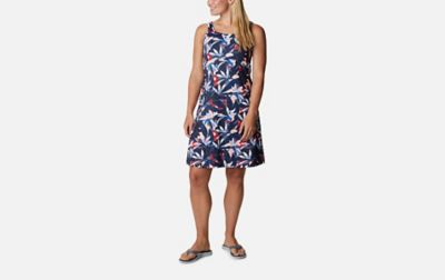 A product shot of a woman wearing a blue floral Columbia Sportswear PFG Freezer III dress with a gray background.