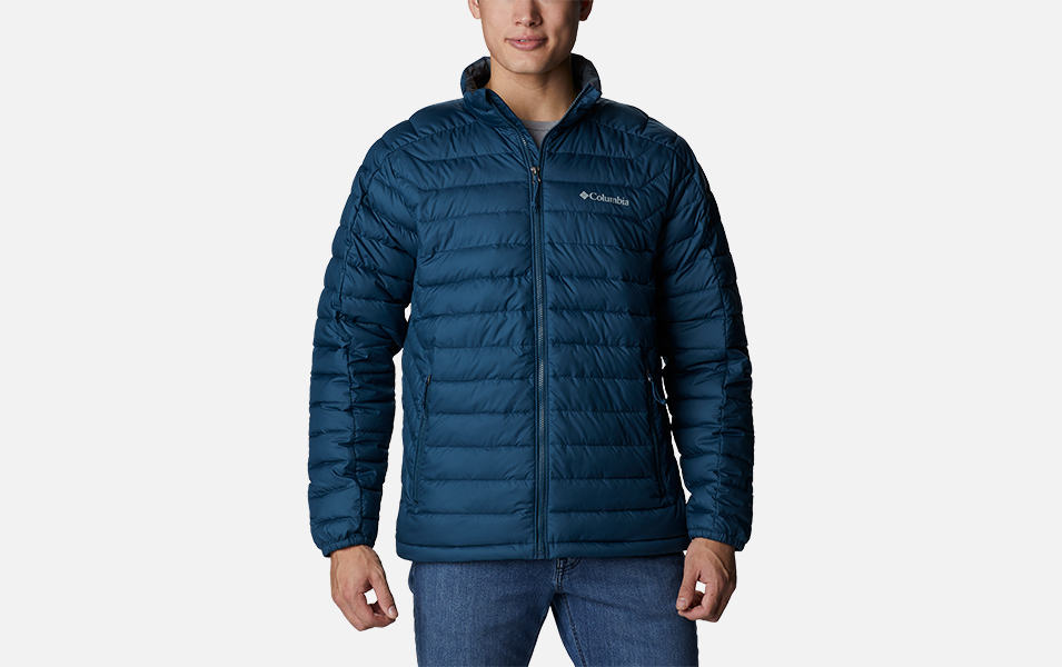 A product shot of a man wearing a blue Columbia Sportswear Wolf Creek Falls insulated jacket with a gray background.
