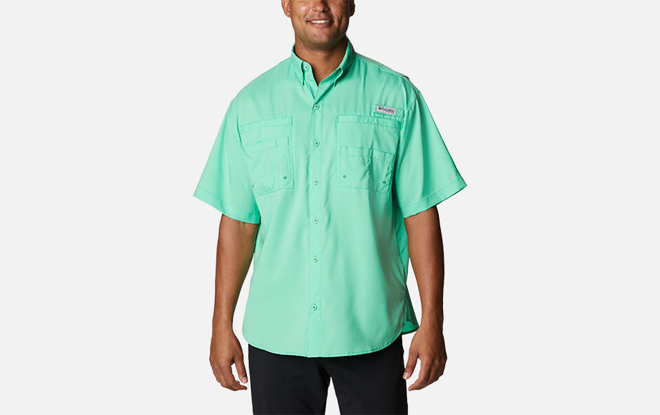 A product shot of a man wearing a turquoise-colored Columbia Sportswear Tamiami II PFG fishing shirt with a gray background.