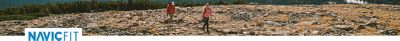 Navic Fit logo over a photo of two people hiking on a rocky landscape. 