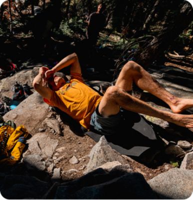 Ethan Pringle taking a break from climbing hunched over