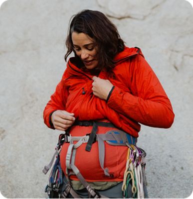 Miranda Oakley looking down at her pregnant belly