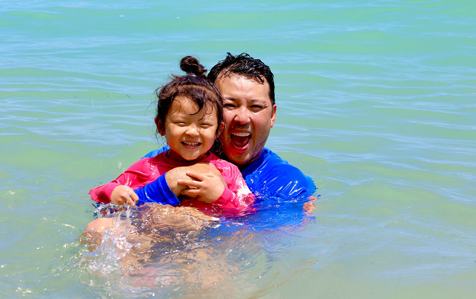 Father and daughter swimming.