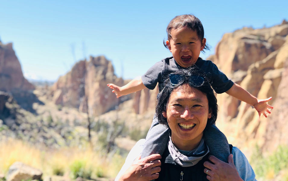 Man with boy on his shoulders at Smith Rock State Park.