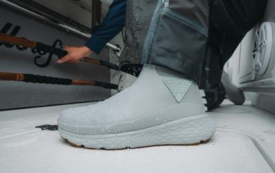 The deck is wet with rain, but an angler has secure footing, thanks to his PFG Pro Sport Boots. 