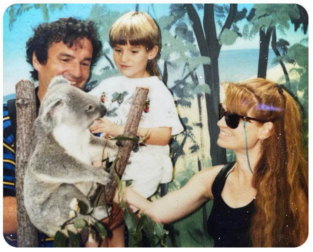 Old family photo of Ethan and his parents with a koala bear while traveling