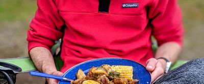 Person holding a plate full of food. 