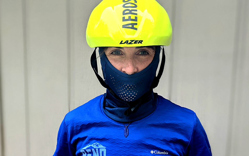 Person wearing a helmet and neck gaiter. 