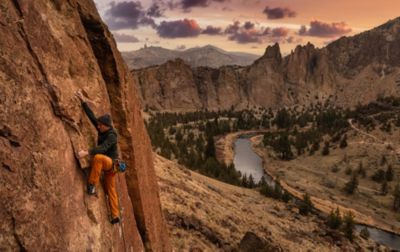 High above the river, a climber wrestles with his next move. 