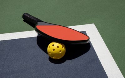 A pickleball racquet and ball.
