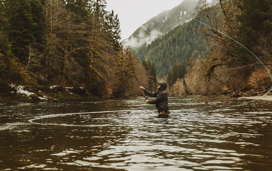 Curtis Ciszek fly fishing in on a river. 