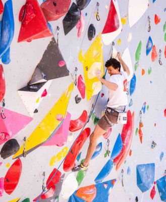 Jesse Grupper climbing in the gym.