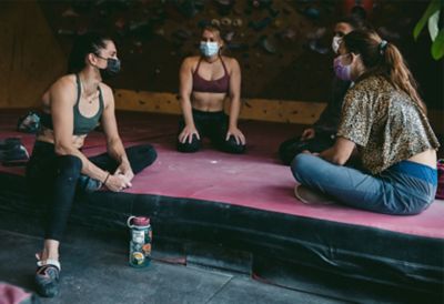 Kyra sitting with other climbers
