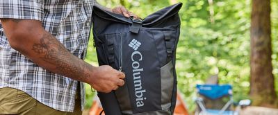 Person holding a Columbia backpack. 