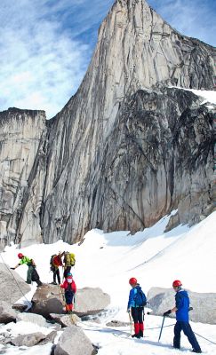 Mountaineering in the high Canadian alpine, a small group takes in the view of the rockface