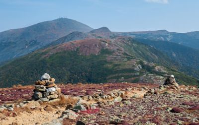 Large rock piles adorn the Appalachian Trail as it winds along the top of a hilly ridge.