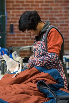 Wendy has been on our team since 2003, repairs a sleeping bag at MHW HQ