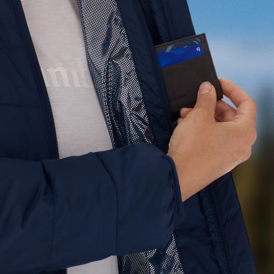 Model placing a wallet in the interior zippered pocket