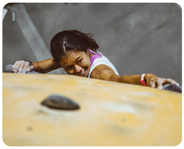 Climber reaches for their next hold at the 2019 Woman Up Event.